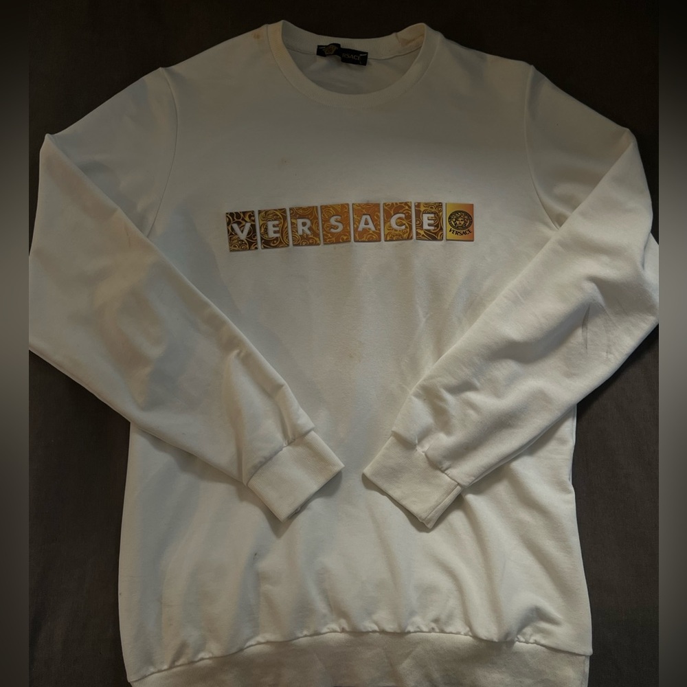 Versace sweater with nice little spot on shoulder but will dry clean before ship
